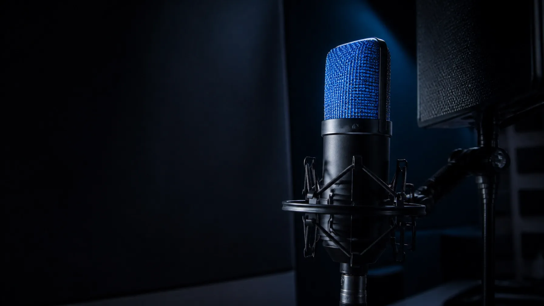 Broadcast microphone catching cobalt-blue studio light